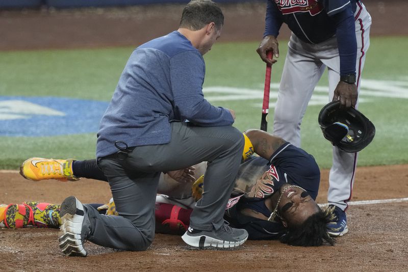 Atlanta Braves Ronald Acuna Jr. (13) grimaces after he was hit by a ball in the left knee during the sixth inning of a baseball game against the Miami Marlins, Thursday, May 4, 2023, in Miami. (AP Photo/Marta Lavandier)
