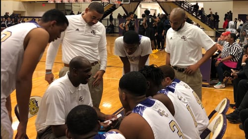 East Cowta’s boys basketball team, coached by Royal Maxwell (center), is 19-1 and ranked No. 3 in Class AAAAAAA after victories over state-powers Wheeler and Pebblebrook. East Coweta has not made the state playoffs since 2005 nor won a state-playoff game since 1964.