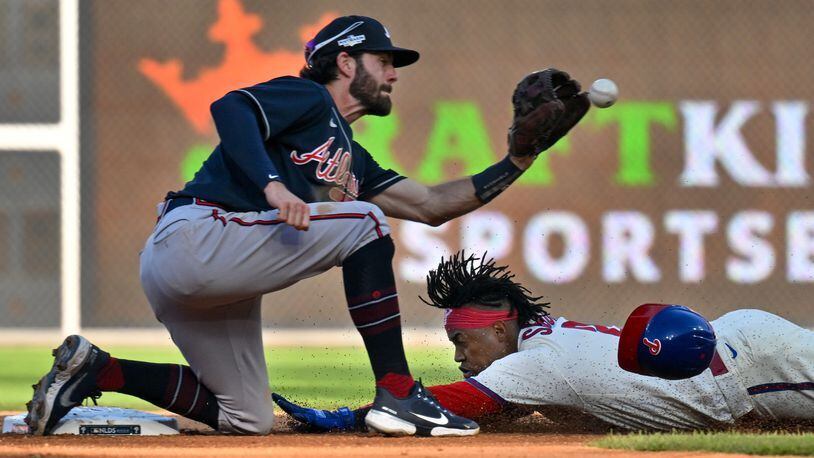 Philadelphia Phillies’ Jean Segura (2) safely steals second base under Atlanta Braves shortstop Dansby Swanson (7) during the sixth inning of game four of the National League Division Series at Citizens Bank Park in Philadelphia on Saturday, October 15, 2022. (Hyosub Shin / Hyosub.Shin@ajc.com)
