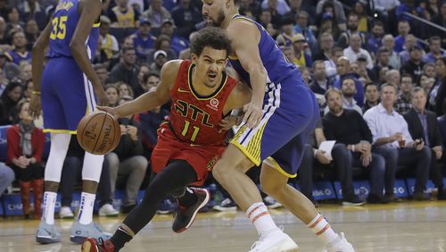 Hawks guard Trae Young, left, drives against Golden State Warriors guard Klay Thompson during the first half of an NBA basketball game in Oakland, Calif., Tuesday, Nov. 13, 2018. (AP Photo/Jeff Chiu)