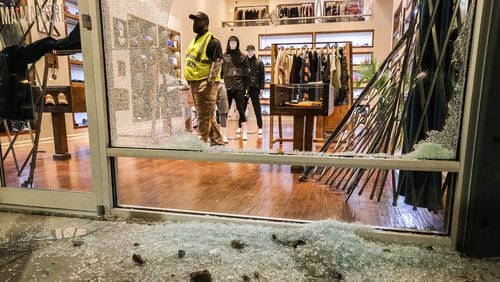 Shattered glass litters the sidewalk outside A Ma Maniere on Marietta Street after the second smash-and-grab burglary in three months. JOHN SPINK/JSPINK@AJC.COM