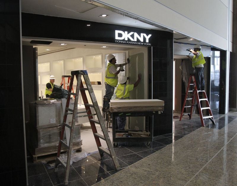 In this 2012 photos, workers prepare the DKNY store at Hartsfield-Jackson International Airport. Bob Andres bandres@ajc.com