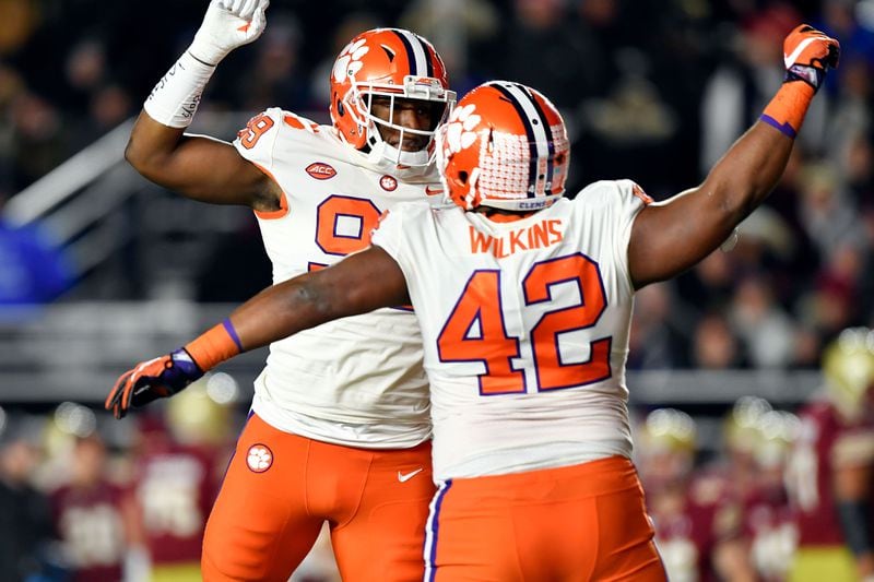 Clemson players Christian Wilkins (42) and Clelin Ferrell celebrate a play during their defeat of Boston College.