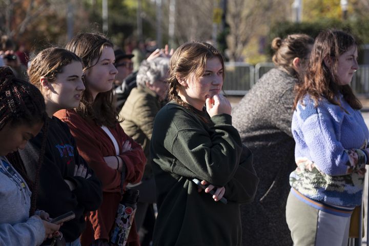People on the edge of the Emory campus wait for the motorcade to pass by following the memorial service for former First Lady Rosalynn Carter in Atlanta on Tuesday, Nov. 28, 2023.   (Ben Gray / Ben@BenGray.com)