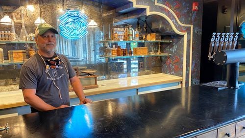 Brian Purcell stands behind the Apothecary bar inside the Three Taverns Imaginarium at the Atlanta Dairies development on Memorial Drive. CONTRIBUTED BY BOB TOWNSEND