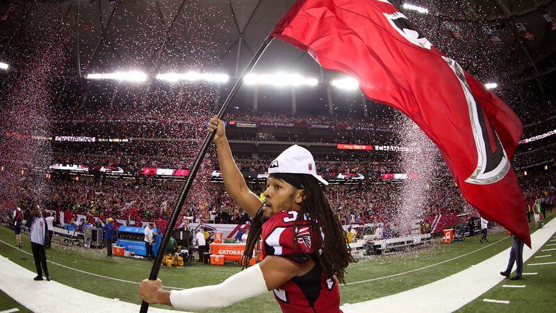  Jalen Collins runs through the field with a Falcons flag after defeating the Green Bay Packers in the NFC Championship Game at the Georgia Dome on January 22, 2017 in Atlanta, Georgia. The Falcons defeated the Packers 44-21. (Tom Pennington/Getty Images)