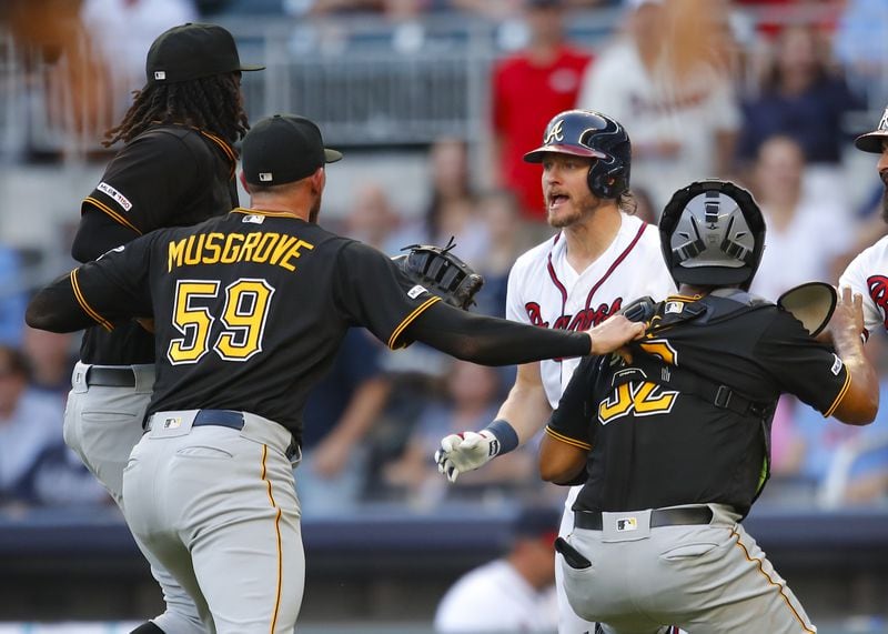 First-inning fireworks: Josh Donaldson of the Braves is restrained after being hit by a pitch as he charges Joe Musgrove of the Pirates during the first inning of Monday's game at SunTrust Park. (Photo by Todd Kirkland/Getty Images)