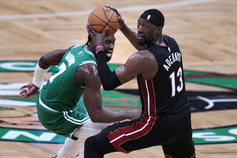 Miami Heat center Bam Adebayo (13) looks to pass the ball while pressured by Boston Celtics guard Jaylen Brown (7) during the second half Game 2 of an NBA basketball first-round playoff series Wednesday, April 24, 2024, in Boston. (AP Photo/Charles Krupa)