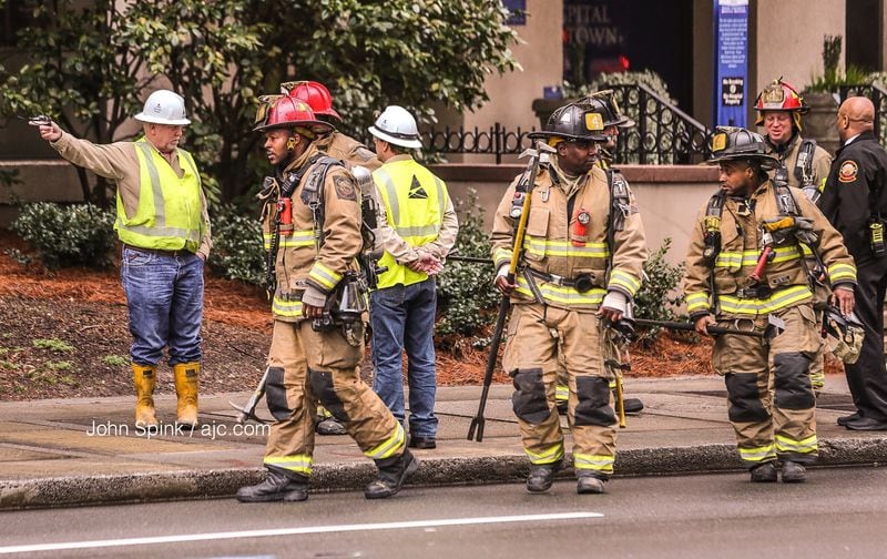 Atlanta fire crews perform a check after an underground explosion was reported near Emory University Midtown. JOHN SPINK / JSPINK@AJC.COM