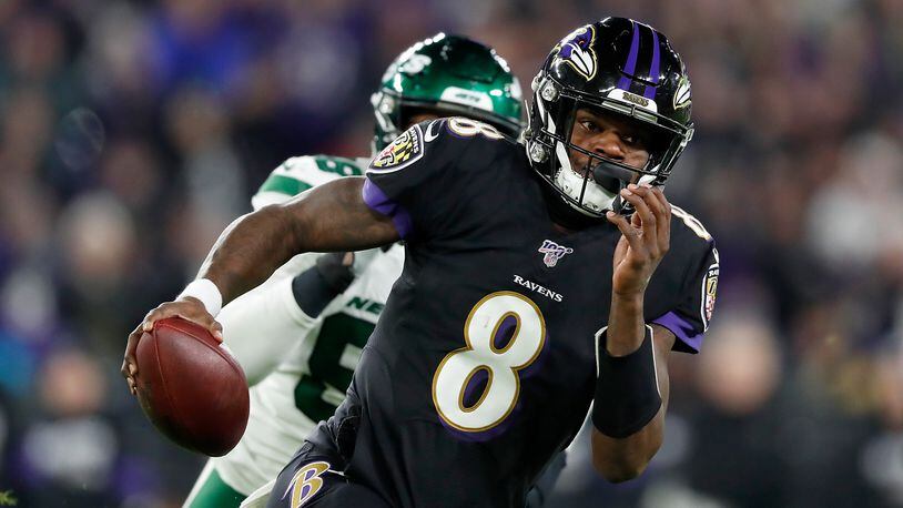 Quarterback Lamar Jackson of the Baltimore Ravens scrambles against the defense of the New York Jets during the game at M&T Bank Stadium on December 12, 2019 in Baltimore, Maryland. (Photo by Scott Taetsch/Getty Images)