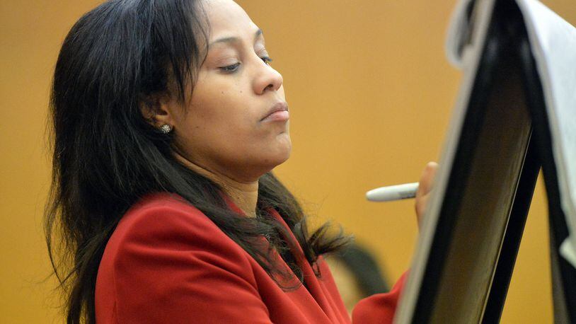 Fulton County Chief Senior Assistant DA Fani Willis writes on a chart as she questions prosecution witness Sharron Pitts on Wednesday. (Kent D. Johnson, Atlanta Journal-Constitution)