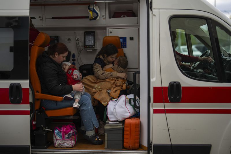 Patients are evacuated from Children's Hospital No. 1 on the outskirts of Kyiv, Ukraine, Friday, April 26, 2024. Doctors and ambulance crews evacuated patients from a Kyiv children's hospital on Friday after a video circulated online saying Russia planned to attack it. (AP Photo/Francisco Seco)