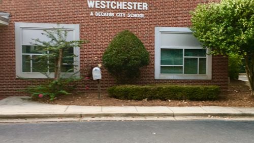 A pedestrian hybrid beacon, getting built this week, will span Scott Boulevard across from Westchester Elementary. The beacon has been sought after by school officials and parents since Westchester reopned in 2014. Bill Banks for the AJC
