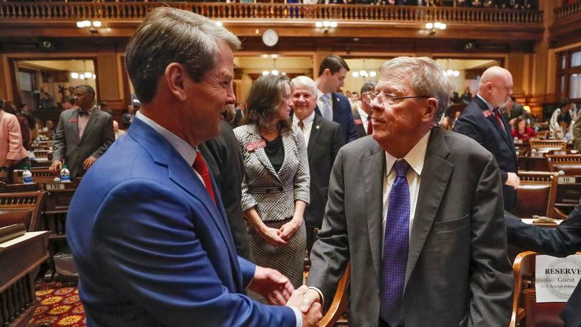 Georgia Gov. Brian Kemp (left) shakes hands with former U.S. Sen. Johnny Isakson after the governor’s State of the State address on Jan. 16, 2020. Kemp announced in his speech that the University of Georgia will create a professorship to research Parkinson’s disease. Isakson retired last year from the Senate after announcing he has the disease.   Bob Andres / bandres@ajc.com