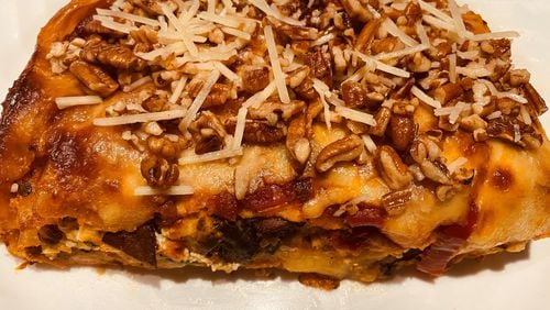 Chicken lasagna Florentine is topped with Parmesan cheese and chopped pecans. Bob Townsend for The Atlanta Journal-Constitution