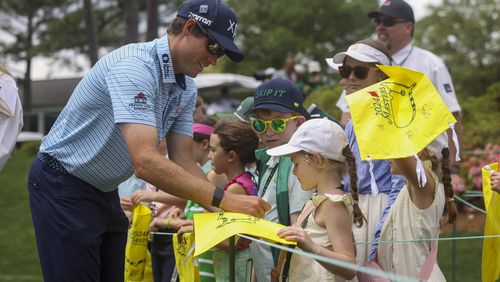 Adam Schenk signs autograph for young golf fans before he tees off on the first hole during the Par 3 contest at Augusta National Golf Club, Wednesday, April 10, 2024, in Augusta, Ga. (Jason Getz / jason.getz@ajc.com)