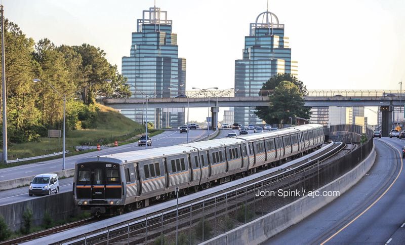 A MARTA train heads southbound from the Medical Center station on the red line Monday morning, hours after a crash involving a train and a contractor in a vehicle shut down the line overnight. JOHN SPINK / JSPINK@AJC.COM