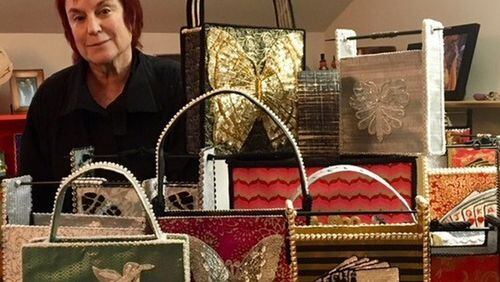 Eve Mannes of Sandy Springs shows off a collection of handbags she designed from imported paper and chopsticks. CONTRIBUTED