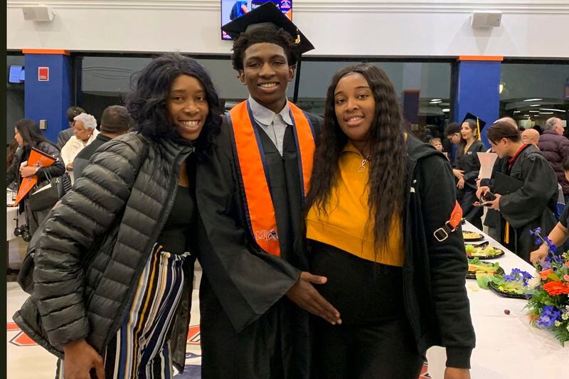 This 2019 photo provided by Porscha Banks shows Dexter Reed, center, along with his mother Nicole Banks and sister Porscha Banks. Reed died March 21, 2024 after Chicago Police officers shot him during a traffic stop. The family filed a wrongful death lawsuit Wednesday, April 24, 2024 accusing the department of “brutally violent” policing tactics. (Porscha Banks via AP, file)