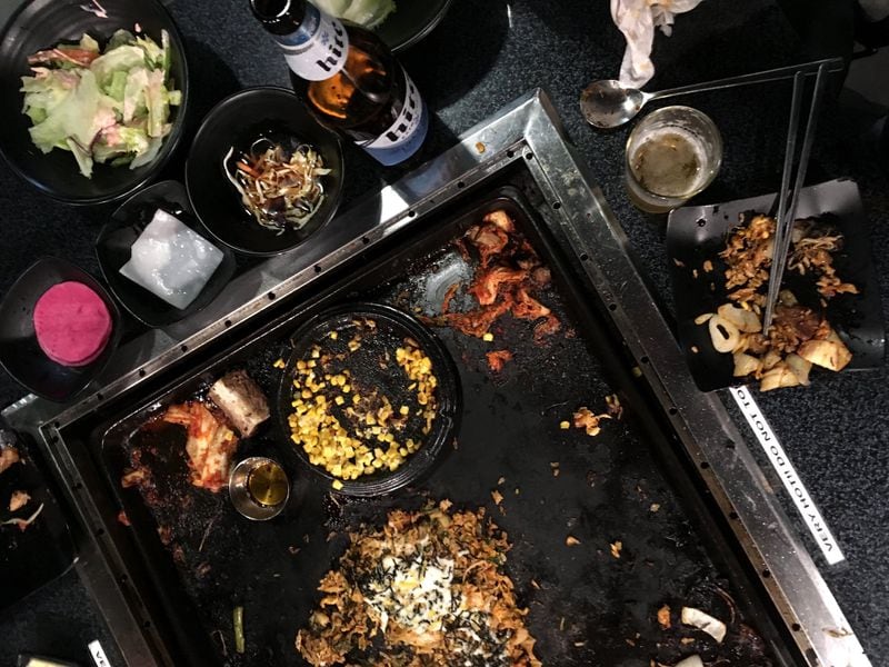 The large, casual tables make for a messy but flavorful meal at Miss Gogi. CONTRIBUTED BY WYATT WILLIAMS