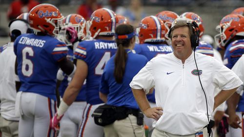 Florida head coach Jim McElwain, right, walks the sidelines during a timeout against Georgia, Saturday, Oct. 28, 2017, in Jacksonville, Fla. Georgia won 42-7.