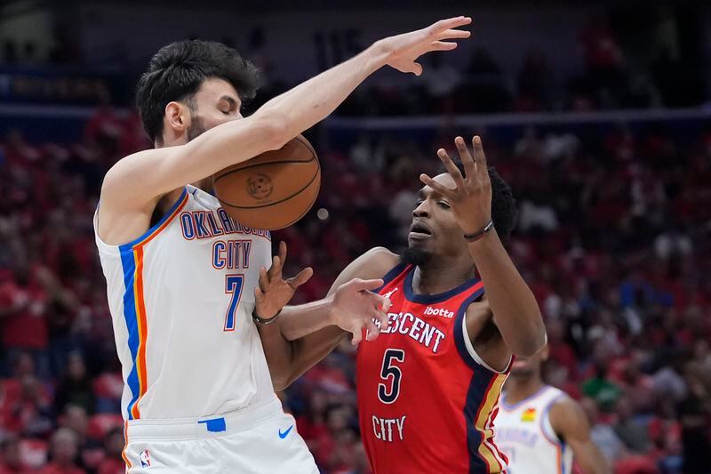 New Orleans Pelicans forward Herbert Jones (5) loses the ball into the arms of Oklahoma City Thunder forward Chet Holmgren (7) in the first half of Game 3 of an NBA basketball first-round playoff series in New Orleans, Saturday, April 27, 2024. (AP Photo/Gerald Herbert)