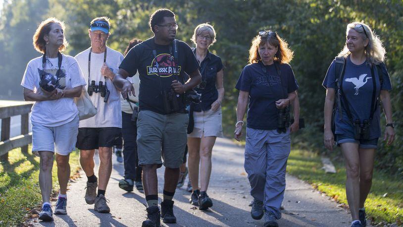 Atlanta Audubon field trip leader Jason Ward (third from left) leads a group of bird watchers during a walk at Azalea Park in Roswell, Thursday, September 6, 2019. (Alyssa Pointer/alyssa.pointer@ajc.com)
