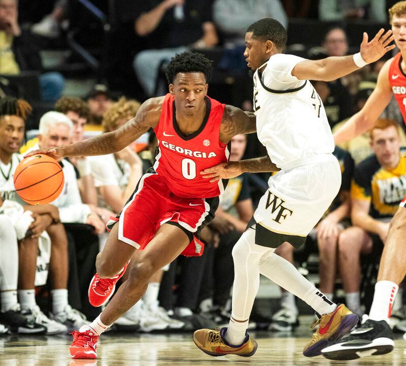 Georgia guard Terry Roberts (0) moves around the defense of Wake Forest guard Daivien Williamson (4) in the first half of an NCAA college basketball game Friday, Nov. 11, 2022, in Winston-Salem, N.C. (Allison Lee Isley/The Winston-Salem Journal via AP)