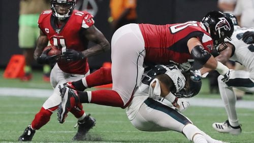Falcons tackle Jake Matthews levels Philadelphia Eagles cornerback Avonte Maddox to free up wide receiver Julio Jones (left) for the long game winning touchdown.  Curtis Compton/ccompton@ajc.com