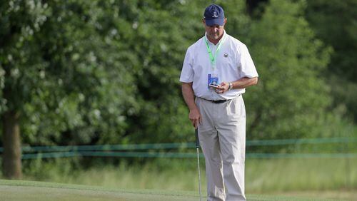 Mike Davis, USGA executive director, does his homework earlier this week at the U.S. Open. (Streeter Lecka/Getty Images)