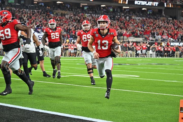 Georgia Bulldogs quarterback Stetson Bennett (13) scores against the TCU Horned Frogs during the first half of the College Football Playoff National Championship at SoFi Stadium in Los Angeles on Monday, January 9, 2023. (Hyosub Shin / Hyosub.Shin@ajc.com)