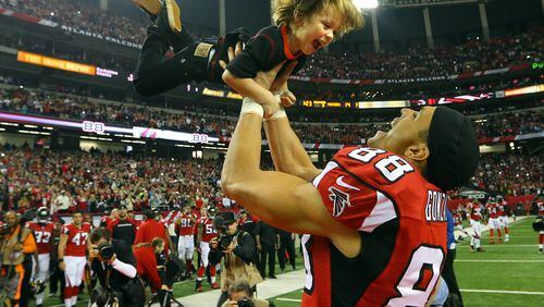 Falcons tight end Tony Gonzalez hoists his 3-year old son River in the air as he runs to greet his father at the conclusion of a half time ceremony honoring his 17-year NFL football career playing in his final game against the Panthers on Sunday, Dec. 29, 2013, in Atlanta.