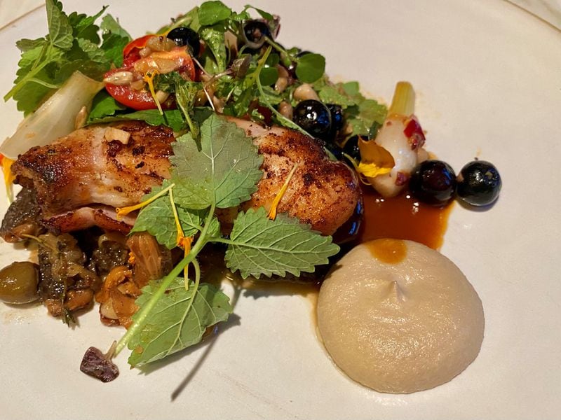 Falling Rabbit’s charred rabbit comes with morel and chanterelle conserva, sunflower crema, smoked blueberries, and a fresh, herby summer salad. 
Wendell Brock for The Atlanta Journal-Constitution