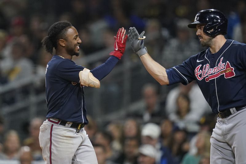 Atlanta Braves' Ozzie Albies, left, celebrates after scoring off an RBI-single by Austin Riley during the first inning. (AP Photo/Gregory Bull)
