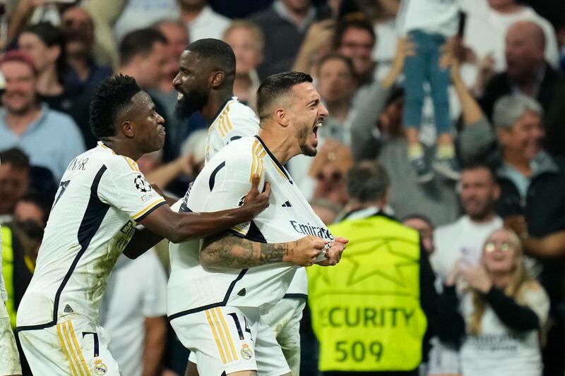 Real Madrid's Joselu, right, celebrates with his teammates after scoring his side's opening goal during the Champions League semifinal second leg soccer match between Real Madrid and Bayern Munich at the Santiago Bernabeu stadium in Madrid, Spain, Wednesday, May 8, 2024. (AP Photo/Jose Breton)
