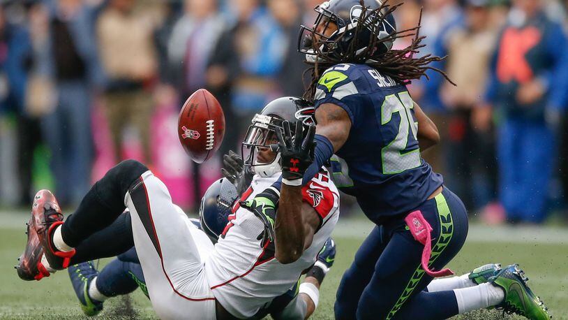 Wide receiver Julio Jones of the Atlanta Falcons can’t make the catch on fourth down as cornerback Richard Sherman of the Seattle Seahawks defends at CenturyLink Field on Oct. 16, 2016 in Seattle, Washington. (Photo by Otto Greule Jr/Getty Images)