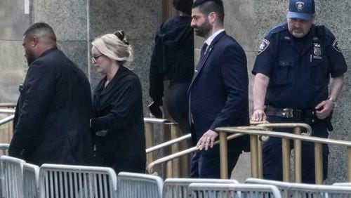 Stormy Daniels (second from left) exits the courthouse in New York, Tuesday, May 7, 2024. Porn actor Daniels, whose real name is Stephanie Clifford, took the stand mid-morning Tuesday and testified about her alleged sexual encounter with Trump in 2006, among other things. (AP Photo/Seth Wenig)