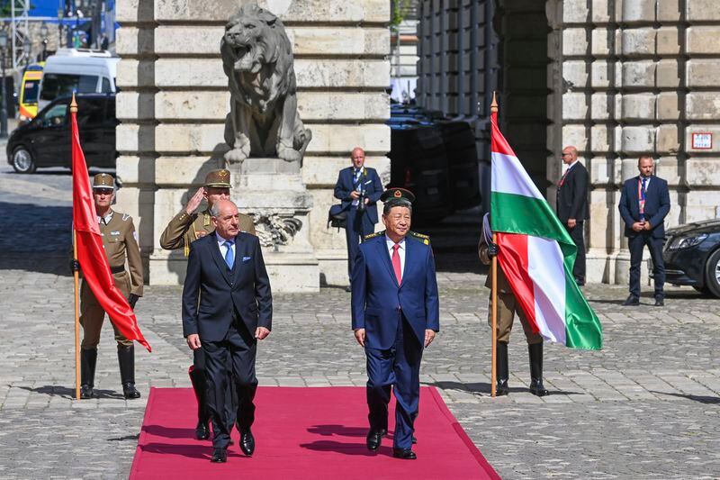 Hungarian President Tamas Sulyok, left, receives Chinese President Xi Jinping, right, with military honours in the Lion Court of the Castle of Buda in Budapest, Thursday, May 9, 2024. (Zoltan Mathe/MTI via AP)
