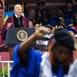 President Joe Biden speaks at the commencement ceremony at Morehouse College as Assistant Professor Taura Taylor raises her fist in protest of the Gaza war in Atlanta on Sunday, May 19, 2024. (Arvin Temkar / AJC)