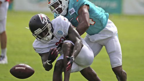 Dolphins cornerback Byron Jones (rear) and Falcons wide receiver Juwan Green run a drill during a joint training camp practice at the Dolphins training facility Wednesday, Aug. 18, 2021, in Miami Gardens, Fla.  (Charles Trainor Jr./Miami Herald)