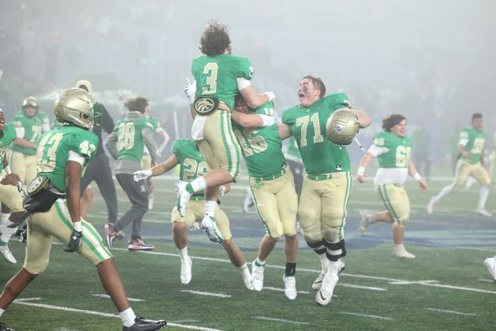 Buford's Eli Parks (3), Will Harkness (16), and Jackson Favors (71) celebrate after Langston Hughes missed the field goal attempt as Buford won 21-20 as time expires during the Class 6A state title football game at Georgia State Center Parc Stadium Friday, December 10, 2021, Atlanta. JASON GETZ FOR THE ATLANTA JOURNAL-CONSTITUTION