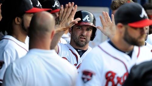 Atlanta Braves second baseman Dan Uggla, center, is greeted in the dugout after scoring against the Colorado Rockies during the second inning of a baseball game Friday, May 23, 2014, in Atlanta. (AP Photo/David Tulis) Dan Uggla's time as a Brave could be nearing an end.