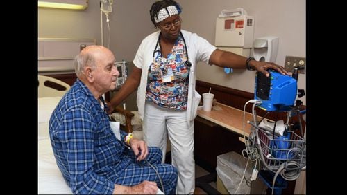 Dianne Minor, a certified nurse assistant, monitors Olin S. Hamlin at Dodge County Hospital in Eastman, Georgia on Sept. 21, 2017. (Rebecca Breyer)