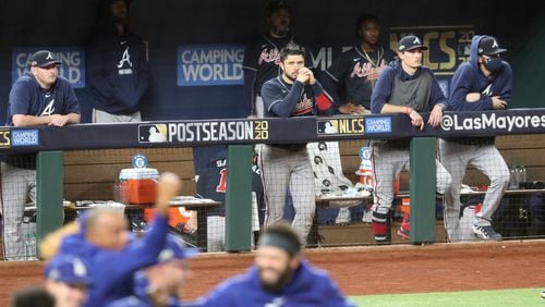 Atlanta Braves players including Tyler Matzek (far left), Travis d'Arnaud (center) and Max Fried (second from right) watch as the Los Angeles Dodgers celebrate their 4-3 win in Game 7 of NLCS Sunday, Oct. 18, 2020, at Globe Life Field in Arlington, Texas.(Curtis Compton / Curtis.Compton@ajc.com)