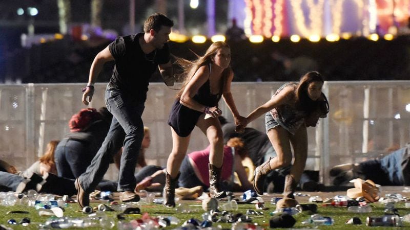 People run for cover at the Route 91 Harvest country music festival in Las Vegas on Oct. 1, 2017, after a gunman opened fire from his nearby hotel room. At least 59 people were killed and more than 500 were injured in the deadliest mass shooting in modern U.S. history.
