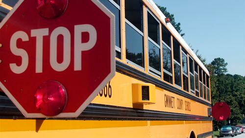 Camera lenses on a Gwinnett County school bus are triggered into recording passing drivers when the bus is stopped.
