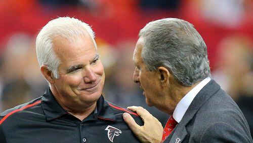 Former Falcons head coach Mike Smith and team owner Arthur Blank greet each other before playing the Steelers in a football on Sunday, Dec. 14, 2014, in Atlanta. CURTIS COMPTON / CCOMPTON@AJC.COM (Curtis Compton, AJC)