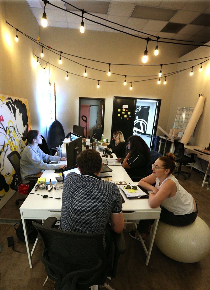 Sarah Biggers, founder of Clove + Hallow, sits with employees in the main office at the company headquarters in Atlanta. Clockwise from left are Colleen Drago, Viktoria Burak, Kesha Smith, Biggers and Tucker Stewart. CURTIS COMPTON / CCOMPTON@AJC.COM