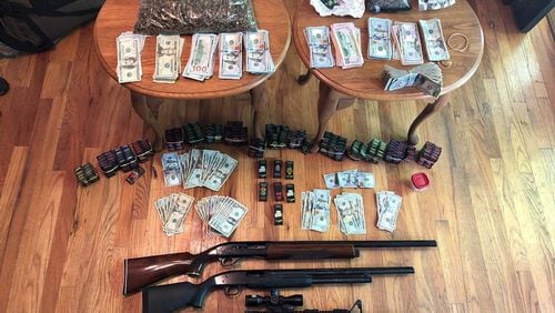 In addition to illegal drugs, authorities seized about $32,000 in cash and three firearms, according to the GBI.