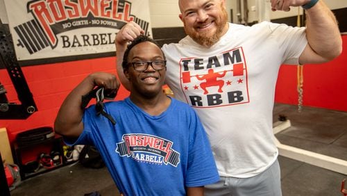 Dave Githutu, a Milton High School weightlifter who regularly competes in the special olympics, trains at Roswell Barbell with his coach Josh Porter. The athlete is competing in England in September. (Jenni Girtman for The Atlanta Journal-Constitution)